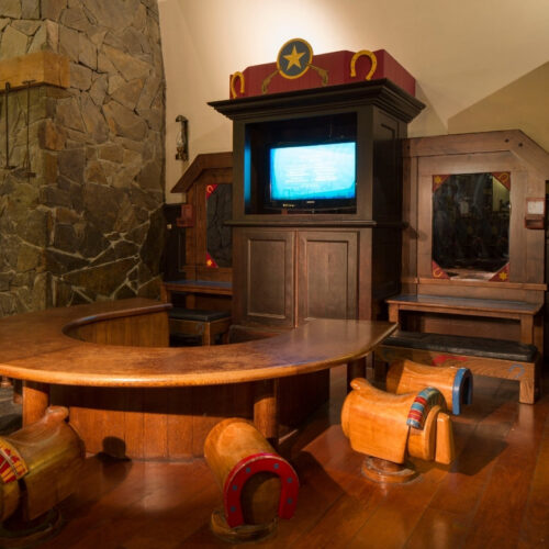 8 Speelhoek in hotel Cheyenne met houten stoelen en een tv