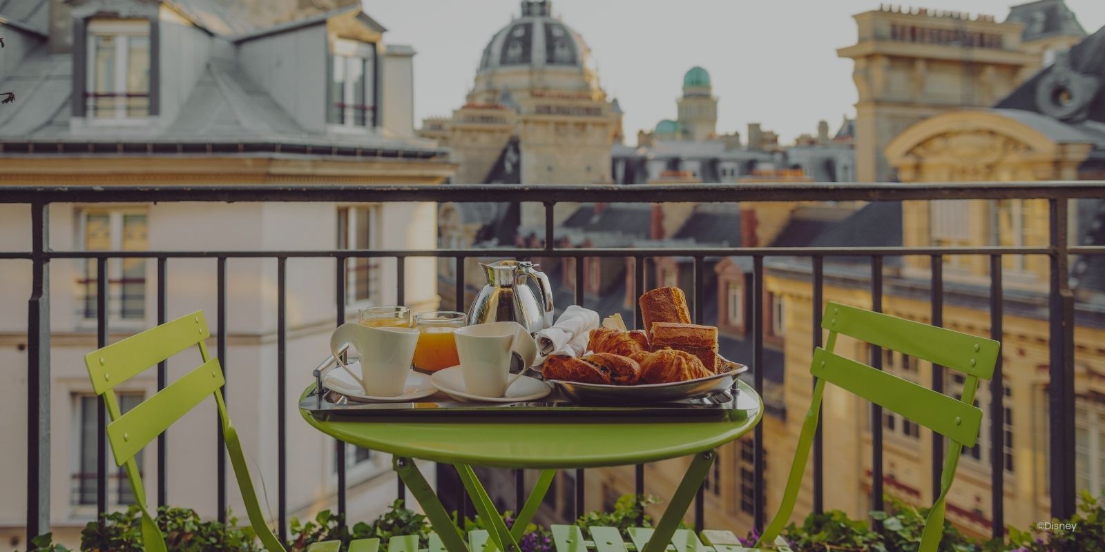 Appartement of Airbnb in het centrum van Parijs. Met een groene tafel met 2 stoetjes met uitzicht over het centrum van Parijs